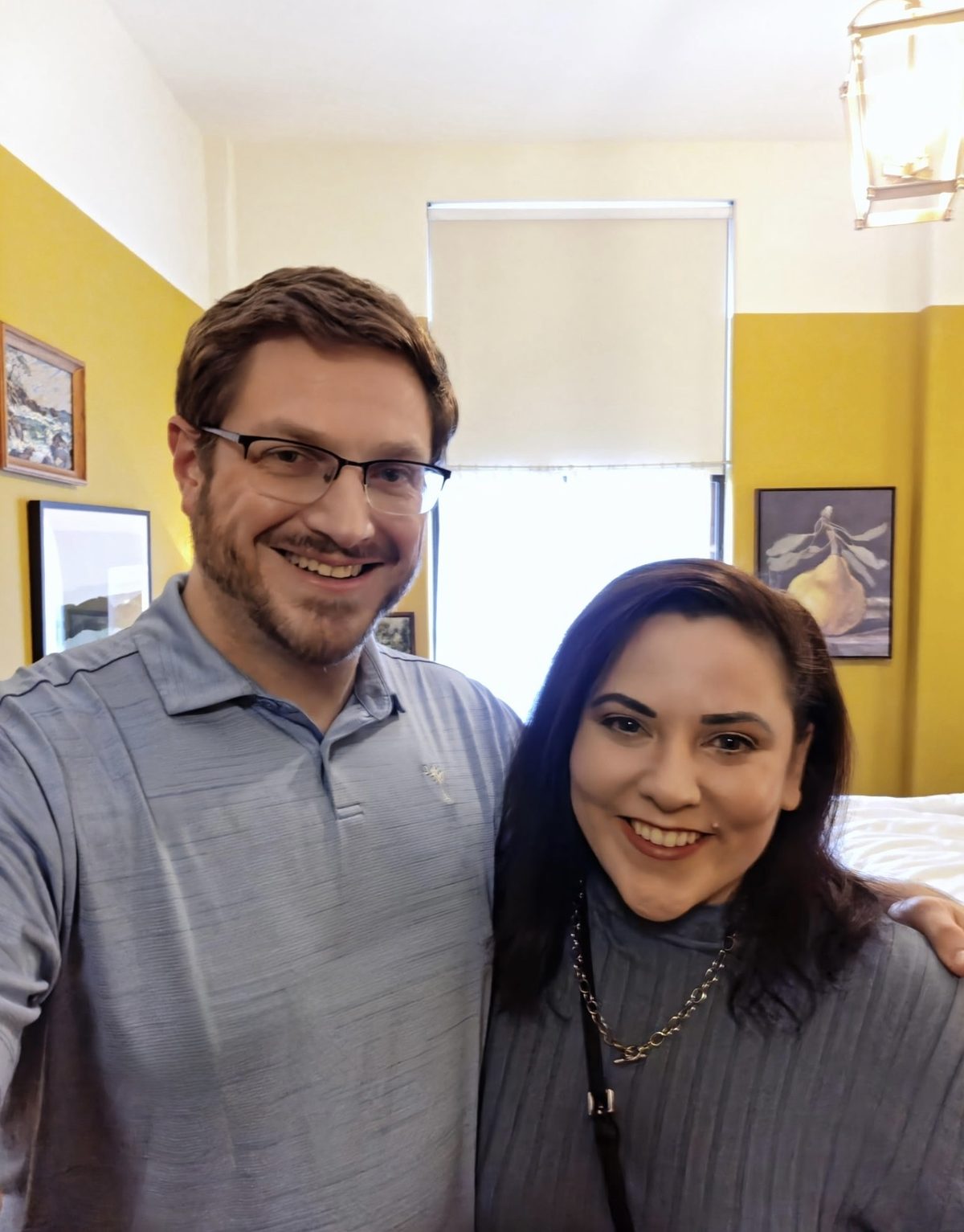 Erin and Andrew at The Abner Hotel in Litchfield, in a room with mustard-yellow walls.