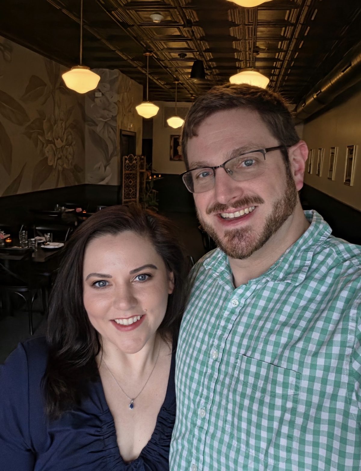 Erin and Andrew at The Laurel, under pressed-tin ceilings and schoolhouse pendant lights.